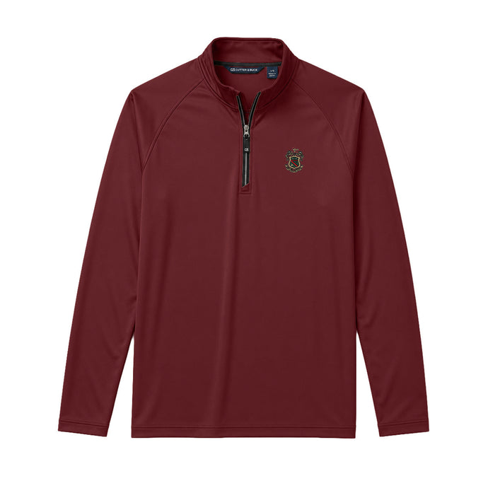 Maroon Cutter + Buck Adapt quarter zip pullover with embroidered crest on the left chest, stand-up collar, and black zipper detailing.