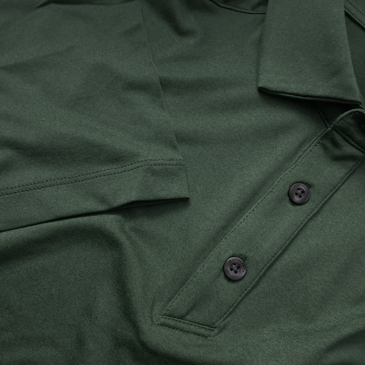 Close up image showing the green heathered Cutter & Buck polo