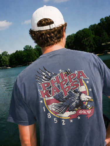 Man wearing a blue comfort colors tee with premium america design