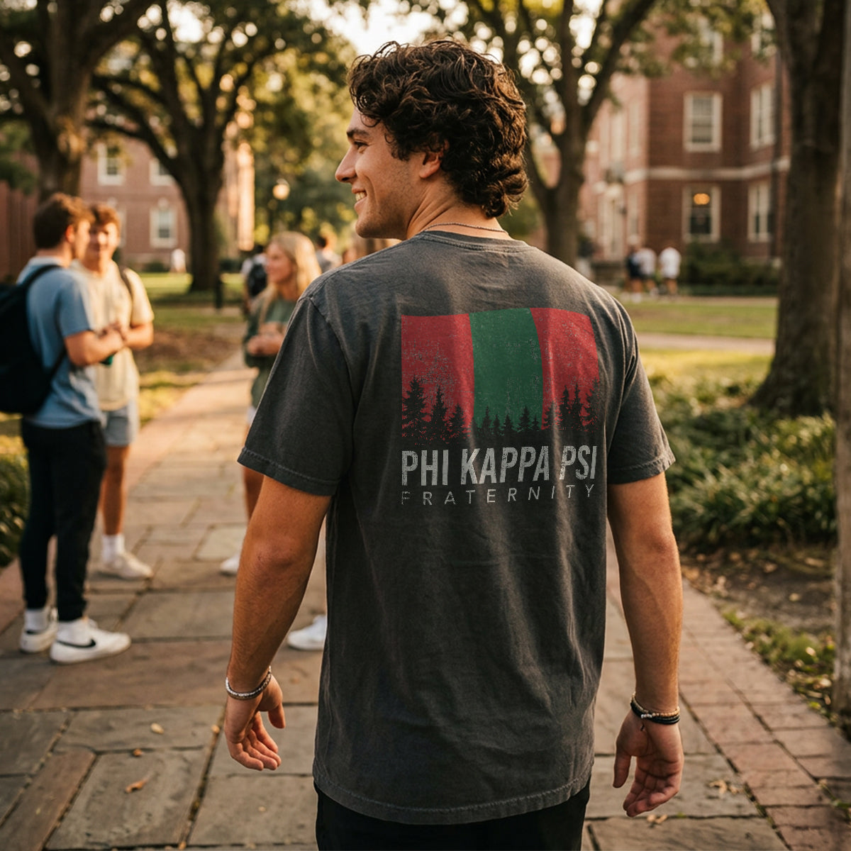 College student wearing fraternity grey t-shirt with colorful flag design on back