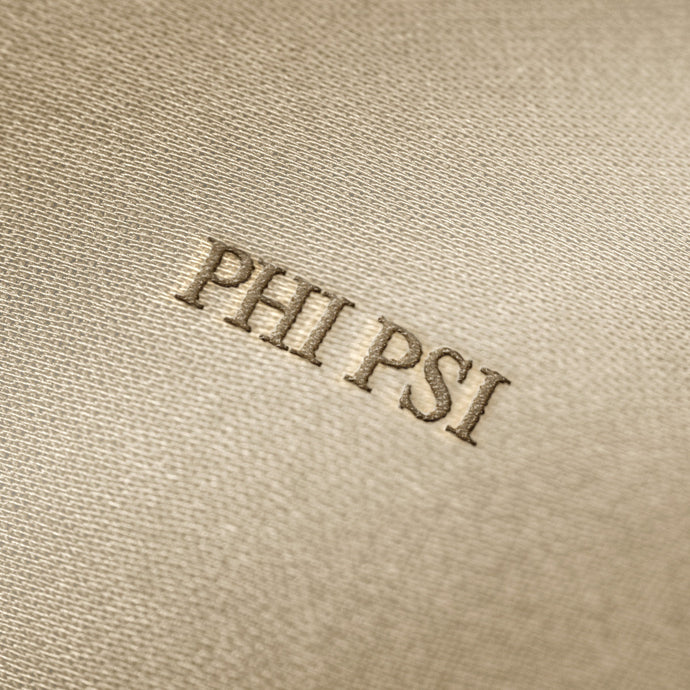 Soft beige fabric close-up showing a smooth, heavyweight knit texture with gentle folds and subtle draping.